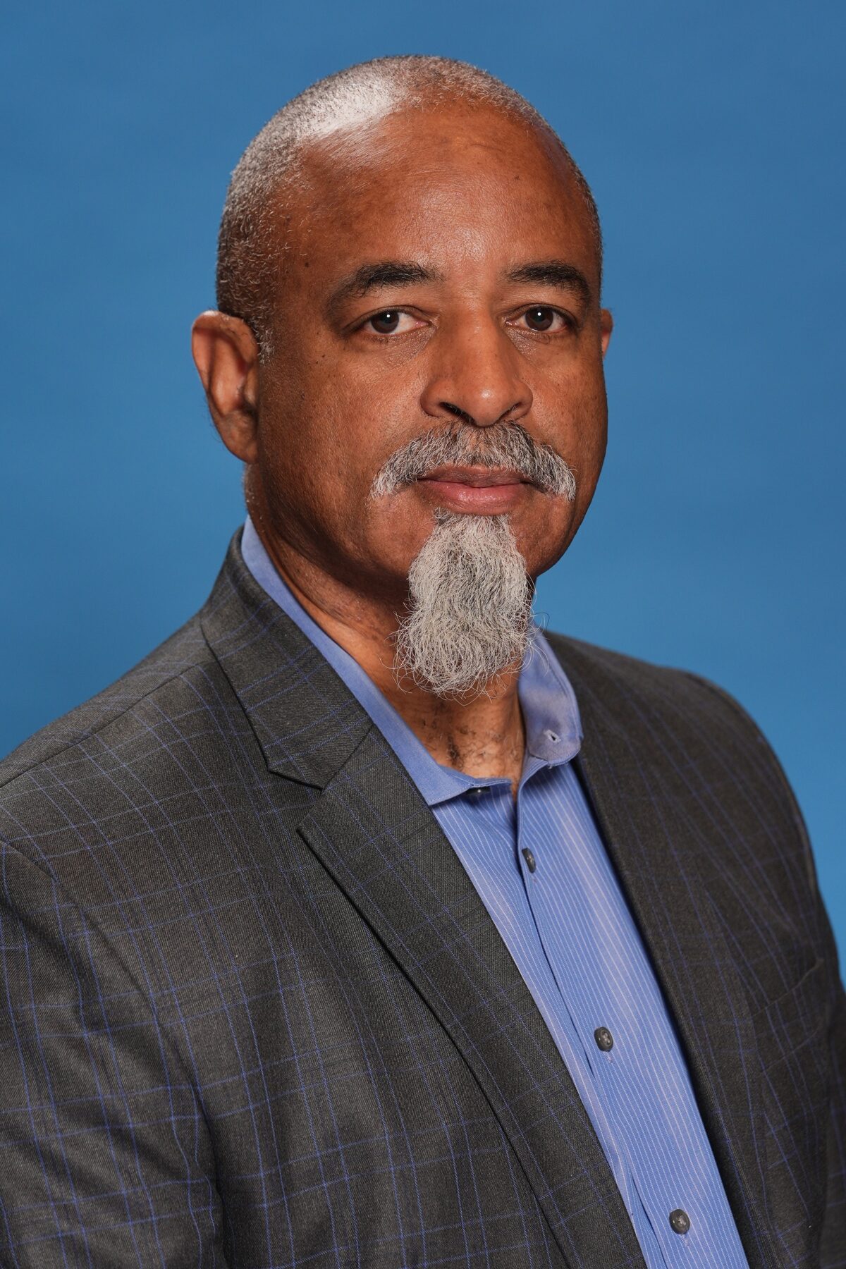 Man in suit against blue background
